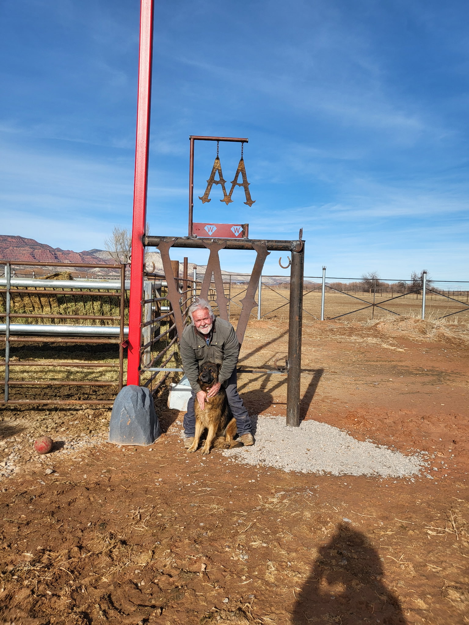 multi-generational ranching family standing together on their ranch during sunset, warm tones